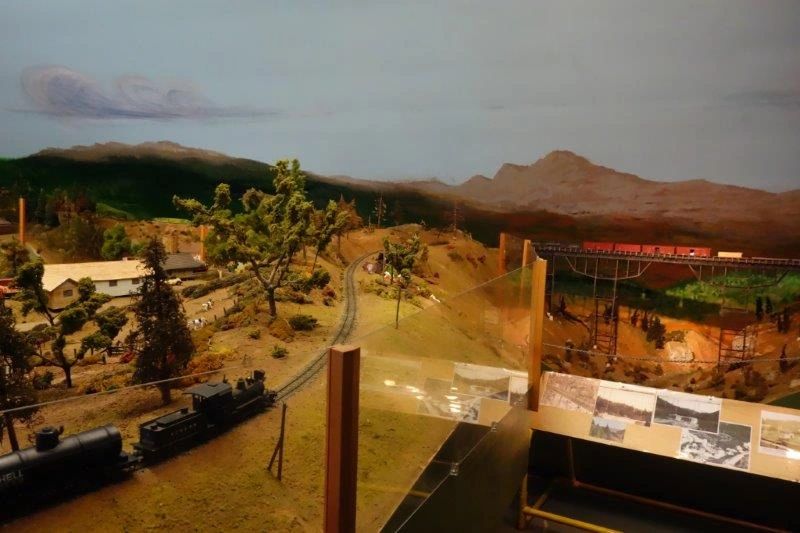 Mountain hillside scene with structures and tracks on the layout