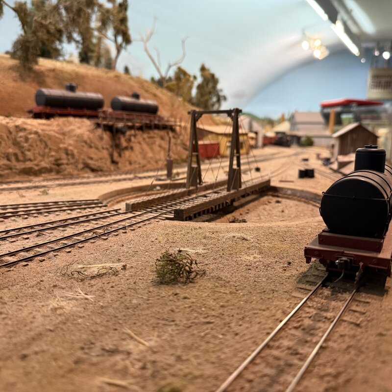Ground-level view of a railroad turntable with a tank car nearby