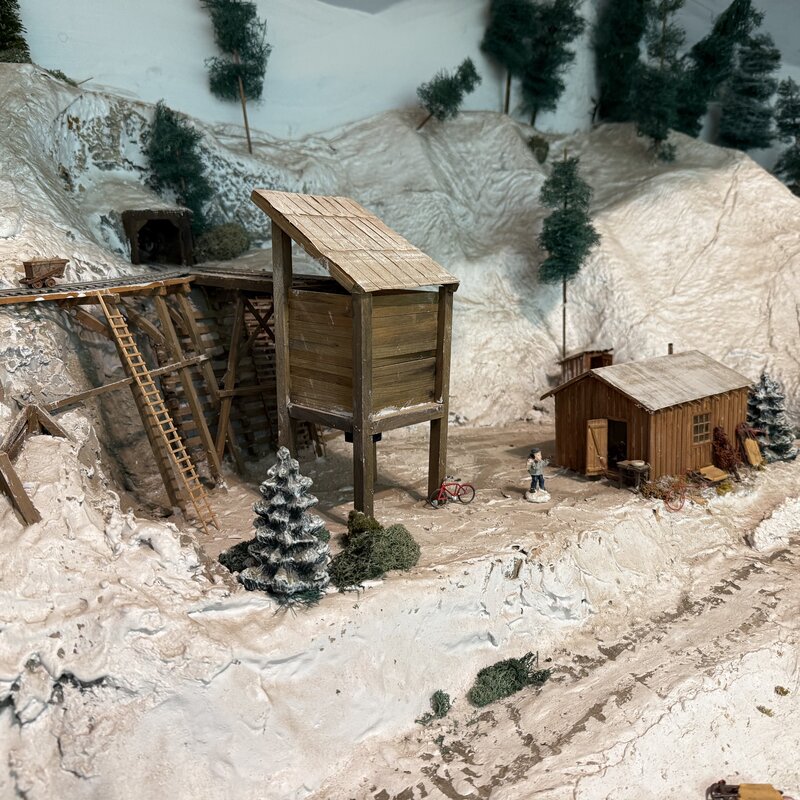Mine scene with a timber ore bin and hillside tunnel