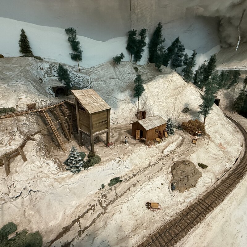 Wide view of a mining scene with tracks curving around the hillside