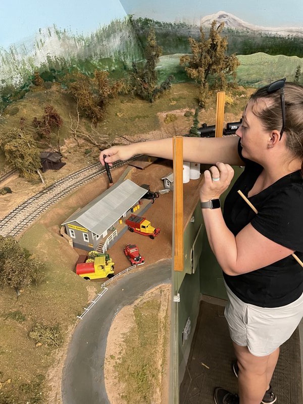 Volunteer detailing structures on the model railroad layout