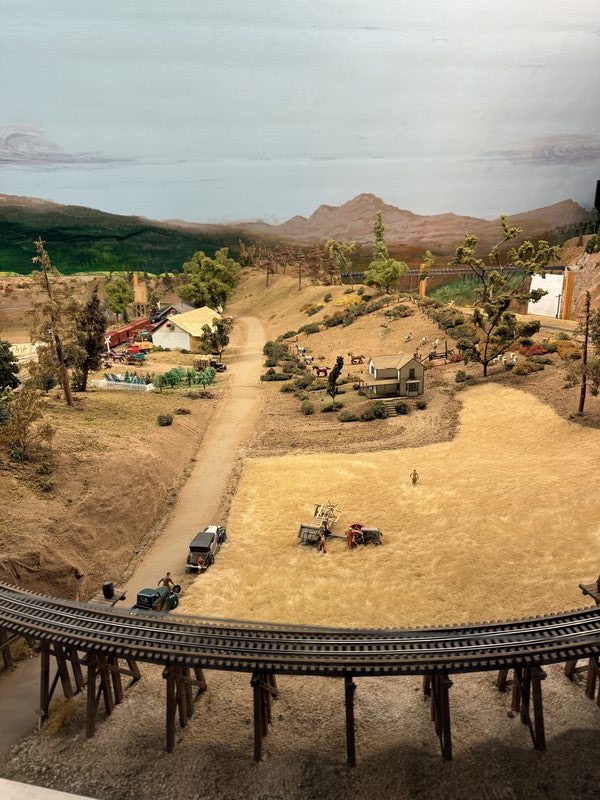 Panoramic view of the layout with trestle bridge and western landscape