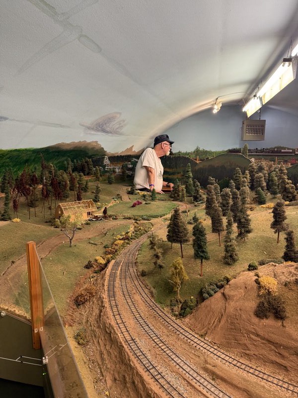 Volunteer at work on the N.C.N.G. layout scenery