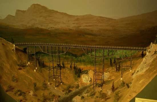 Close-up of a model train on the N.C.N.G. layout with detailed scenery