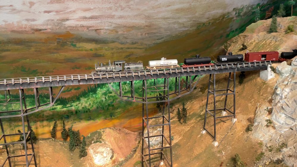 Freight train crossing the Bear River Bridge trestle with tank cars and boxcars